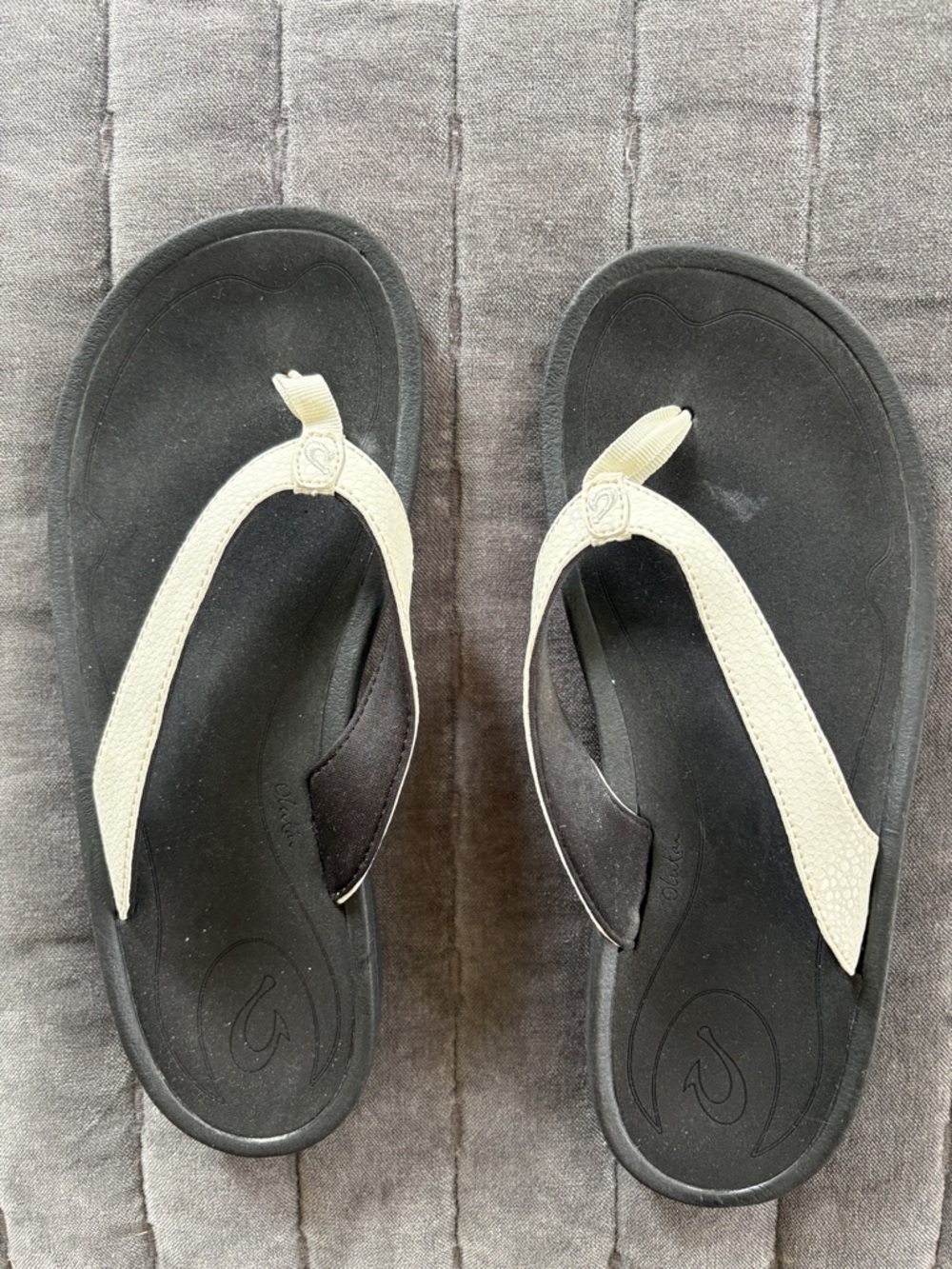 Olukai Black Flip Flops with Cream Straps
